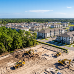 Vista aérea de maquinaria de construcción trabajando en nuevos proyectos residenciales cerca de áreas boscosas en Florida.